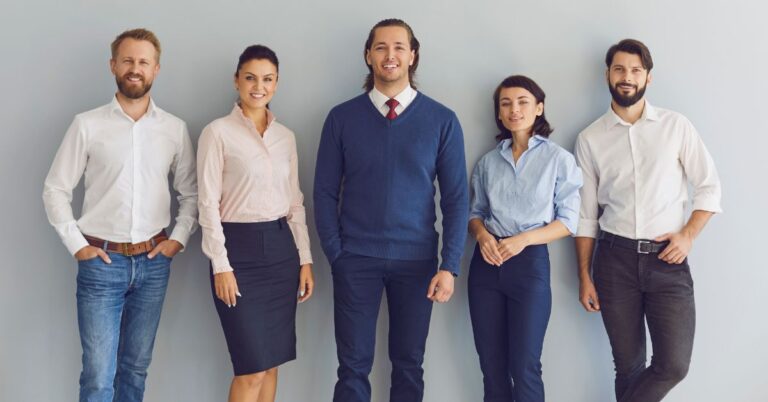 Group of business professionals standing together, representing workplace collaboration and intrapreneurship.