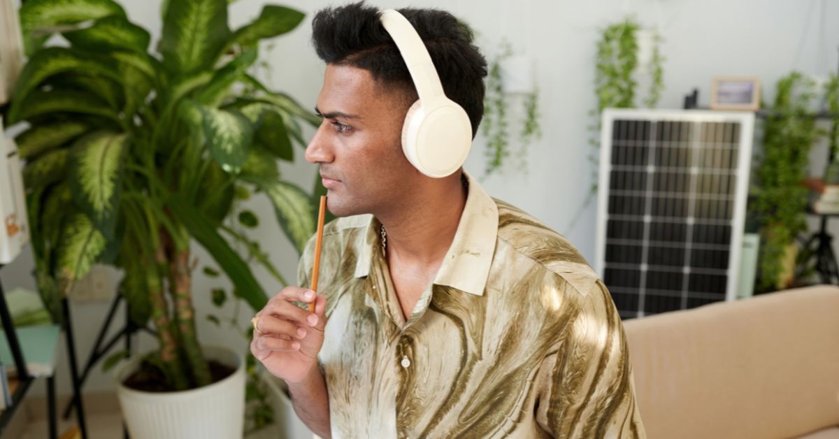 Person wearing headphones while listening, representing text-to-speech audio, MP3 voice content, and AI-generated narration for business content.