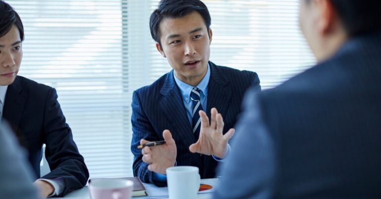 Business professionals discussing strategy during an office meeting.