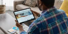 LinkedIn's creator marketplace is invite-only — but the best part isn't Person using a tablet to view LinkedIn while sitting at home with a laptop nearby.