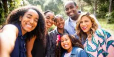 A Canadian family of four could spend nearly $1,000 more on food in 2026: what it means for businesses Smiling family posing together for an outdoor selfie in a sunny park.