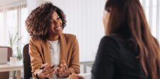 GPT-5.6 is here: what it means for your business Two women having a conversation across a desk in a bright office.