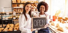 Is The RBC Digital Choice Business™ Account Package Right For You? Two bakery workers smiling while holding an open sign in front of a pastry display.