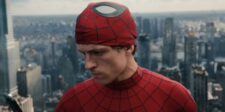 What Spider-Man: Brand New Day's marketing campaign can teach you about launching anything A young man in a red web-patterned superhero suit with his mask rolled up, looking down against a blurred city skyline.
