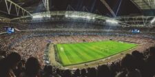 World Cup semifinals start at 3 p.m. ET: make a business plan Crowded soccer stadium during a match, viewed from the stands under bright stadium lights.