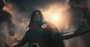 Armored masked figure standing in a dramatic smoky scene.