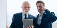 CISA's latest warning puts three business systems on alert Two business professionals looking concerned while reviewing information on a tablet.