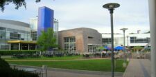 Googleplex courtyard at Google headquarters in Mountain View, California, with office buildings, outdoor seating, and landscaped grounds.