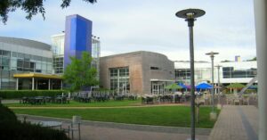Googleplex courtyard at Google headquarters in Mountain View, California, with office buildings, outdoor seating, and landscaped grounds.