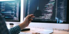 Brevo confirms ClickFix supply-chain attack tied to stolen Cloudflare key Developer reviewing code across multiple computer screens during a website security investigation.