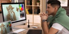 California creates a standalone tax credit for VFX and post-production work Visual effects artist reviewing digital artwork on multiple computer screens.