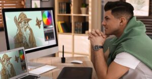 Visual effects artist reviewing digital artwork on multiple computer screens.