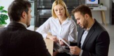 Ottawa’s new mega deduction targets business investment in software and equipment Three business professionals reviewing a document together during a meeting.