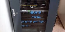 Network equipment rack with connected Ethernet cables and enterprise networking hardware.