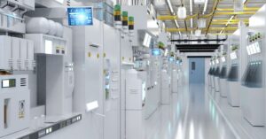 Modern semiconductor fabrication facility with rows of automated chip manufacturing equipment.