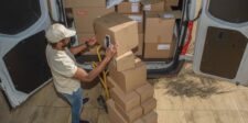 EU’s €3 parcel duty is already changing ecommerce sales patterns Delivery worker scanning packages beside a van loaded with cardboard parcels.