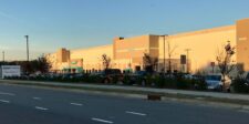 Amazon fulfillment center in Garner, North Carolina, with cars parked outside the warehouse.