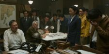 Godzilla Minus Zero gets the Godzilla franchise’s first MPA R rating Film characters gathered around a table in a dimly lit office scene from Godzilla Minus Zero.