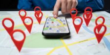 Smartphone displaying a map surrounded by location pins representing nearby businesses.