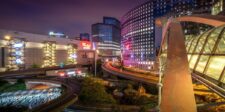 93% of AI Mode users never click. Now the EU wants answers. Night view of La Défense in Paris with office towers, elevated roads, and the illuminated Westfield shopping centre.