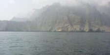 Hormuz shipping traffic drops again as tanker attacks keep cost risk alive Musandam Peninsula mountains rising above the sea near the Strait of Hormuz