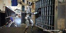 Boston Dynamics Atlas humanoid robot performing parts-sequencing work in a factory training environment.