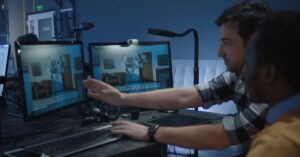 Animation artists reviewing a 3D character scene across multiple computer monitors.
