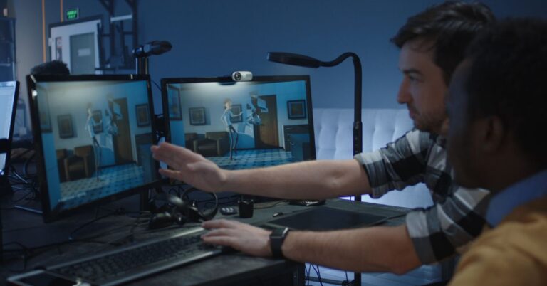 Animation artists reviewing a 3D character scene across multiple computer monitors.