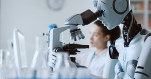 Humanoid robot using a microscope beside a scientist in a laboratory.