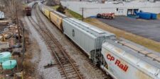 Record rail fuel surcharges squeeze grain costs at harvest Grain hopper railcars traveling on freight tracks, including a CP Rail car.