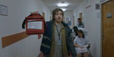 Resident Evil’s record opening turns a risky reboot strategy into a box office win Medical courier carrying a red delivery bag through a hospital hallway in a scene from Resident Evil.