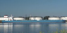 Crude oil tanker Advantage Smooth passing storage tanks along the Calandkanaal in the Netherlands.