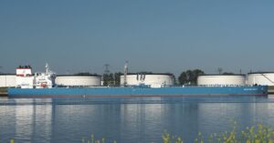 Crude oil tanker Advantage Smooth passing storage tanks along the Calandkanaal in the Netherlands.