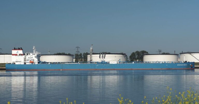 Crude oil tanker Advantage Smooth passing storage tanks along the Calandkanaal in the Netherlands.