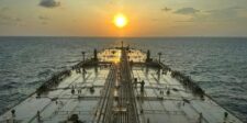 Million-dollar tanker rates show energy’s new bottleneck is ships View across the deck of a crude oil tanker traveling at sea at sunset.