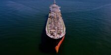 Tracked Hormuz shipping drops back toward zero Aerial view of a large oil tanker travelling alone across open water.