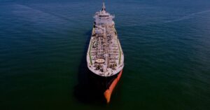 Aerial view of a large oil tanker travelling alone across open water.