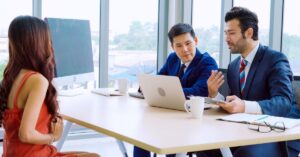 Job candidate meeting with interviewers in an office, illustrating Canada’s weaker hiring market after September job losses.