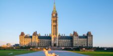 Canada’s Parliament buildings and Peace Tower in Ottawa, with the Centennial Flame in the foreground.