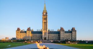 Canada’s Parliament buildings and Peace Tower in Ottawa, with the Centennial Flame in the foreground.