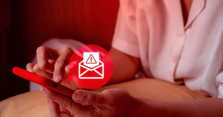 Hands using a smartphone with an email warning symbol.