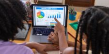 ChatGPT referral traffic may be hiding in Direct reports Two people reviewing website traffic analytics on a laptop, illustrating how ChatGPT referrals may be misclassified as Direct traffic.