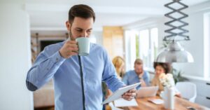 Small-business owner reviewing financial information on a tablet while working with a team.