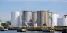 Diesel shortage pushes governments toward reserve releases and export limits Large petroleum storage tanks at a waterfront fuel terminal, illustrating diesel supply and reserve-release pressures.