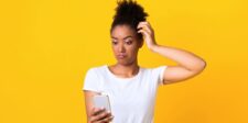 Confused woman looking at her smartphone, illustrating strange and unsuccessful mobile apps.