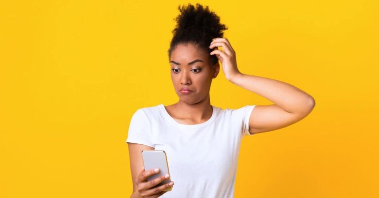 Confused woman looking at her smartphone, illustrating strange and unsuccessful mobile apps.