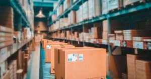 Labelled cardboard parcels on a warehouse conveyor belt