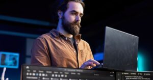 Man using a laptop, illustrating a fake Claude installer campaign that tricked users through search ads and redirects.