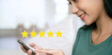 How to fix your online reputation without making it worse Woman using a smartphone beside a five-star rating graphic, illustrating online reviews and business reputation.