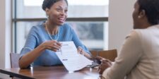 Funding for small businesses in Canada: choose the right money before you apply Business owner discussing a funding application with a financial advisor across a table.